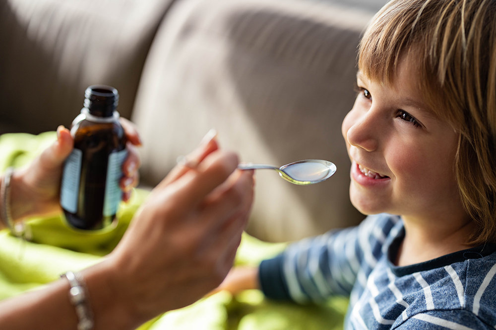 Augmentin sospensione orale per bambini: dosaggio, usi ed effetti collaterali 31 Bambino sorridente con infezione in corso che assume Augmentin sospensione orale per una pronta guarigione