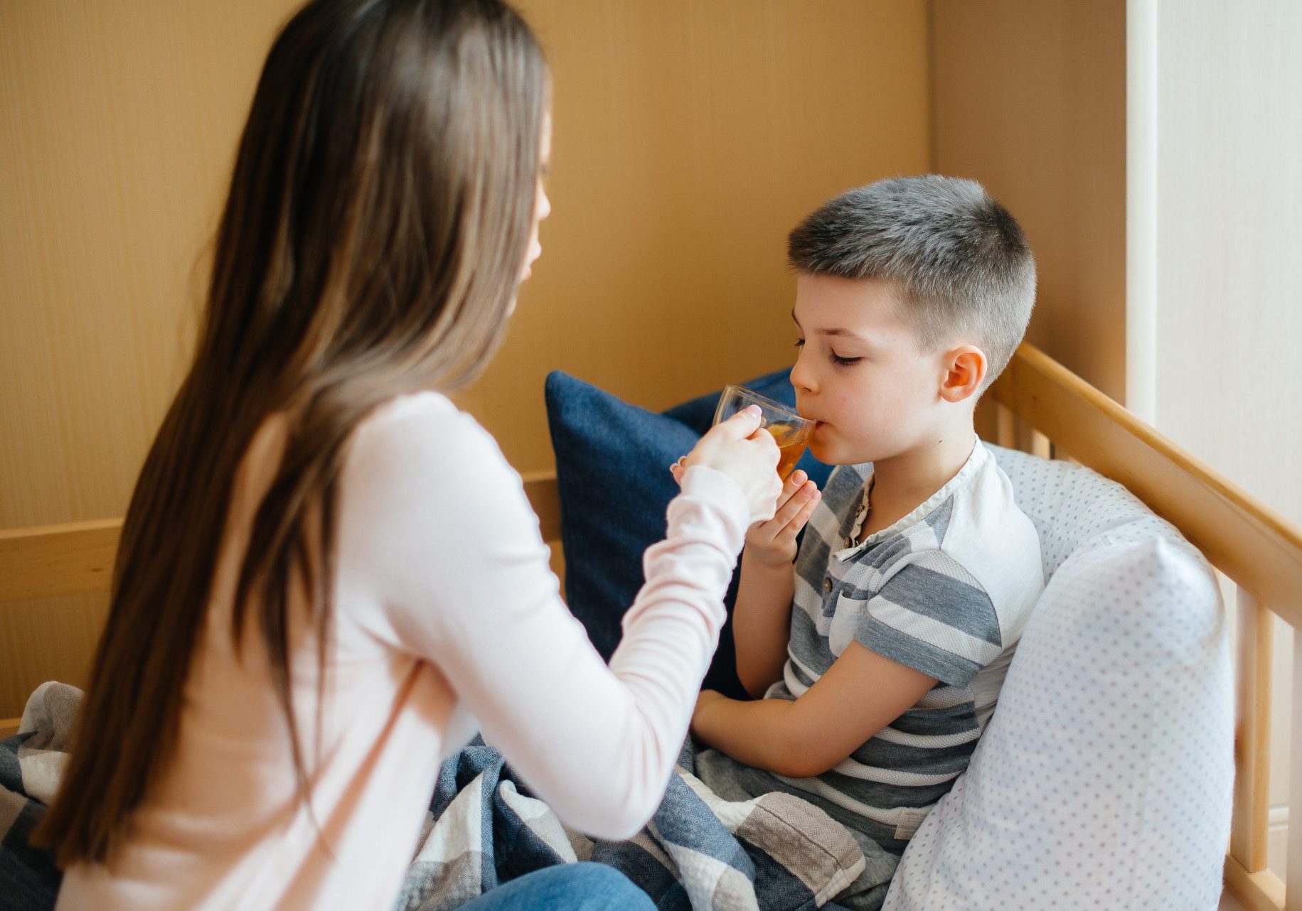 madre da dà bere al figlio ammalato